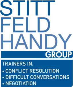 Stitt Feld Handy Group white and blue logo
